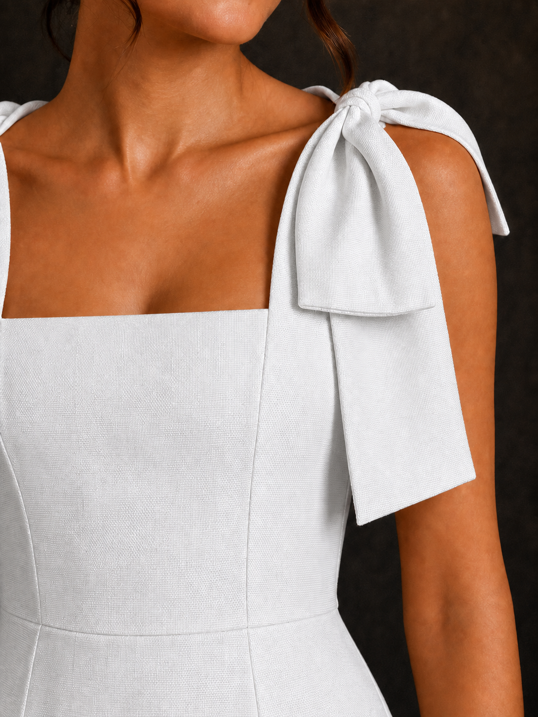 Aurora White dress – close-up of the structured cotton and shoulder bow
