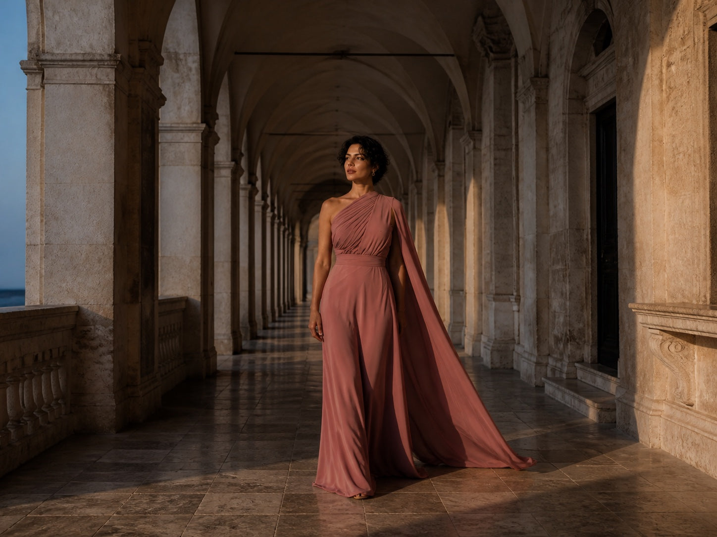Monci model walking through a limestone arcade