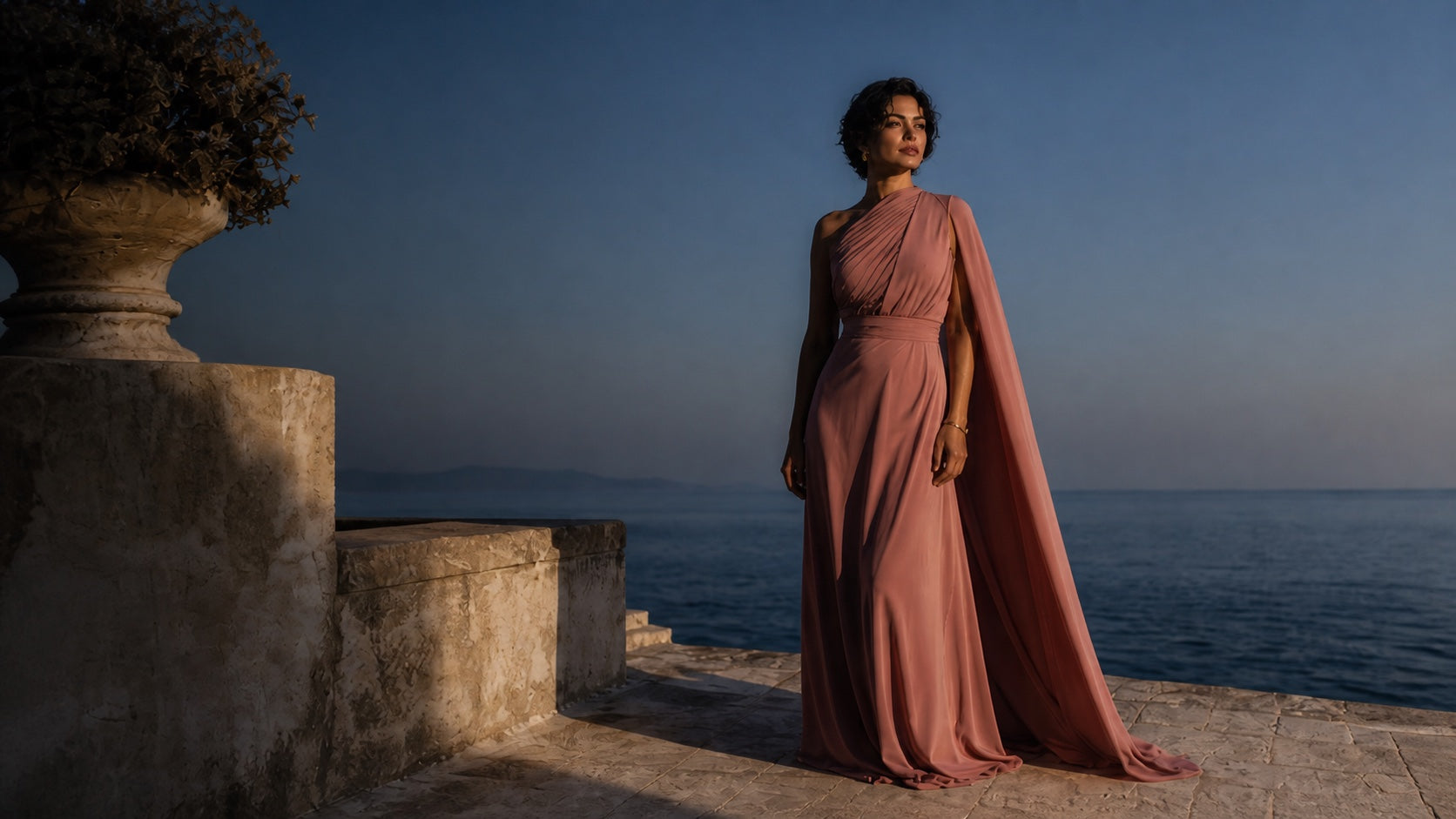 Monci model in a dusty rose dress on an Adriatic stone terrace